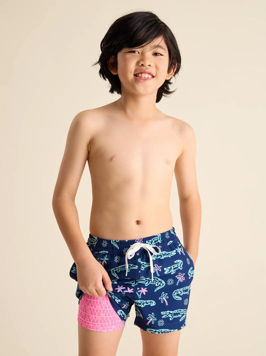 Chubbies The Neon Glades Boys Lined Classic Swim Trunk | Shorter, Navy Alligator/Pink Triangle Liner